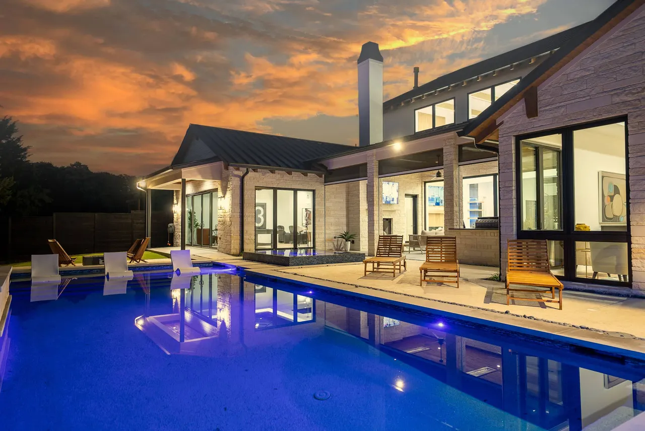 Modern custom pool and outdoor living space at sunset