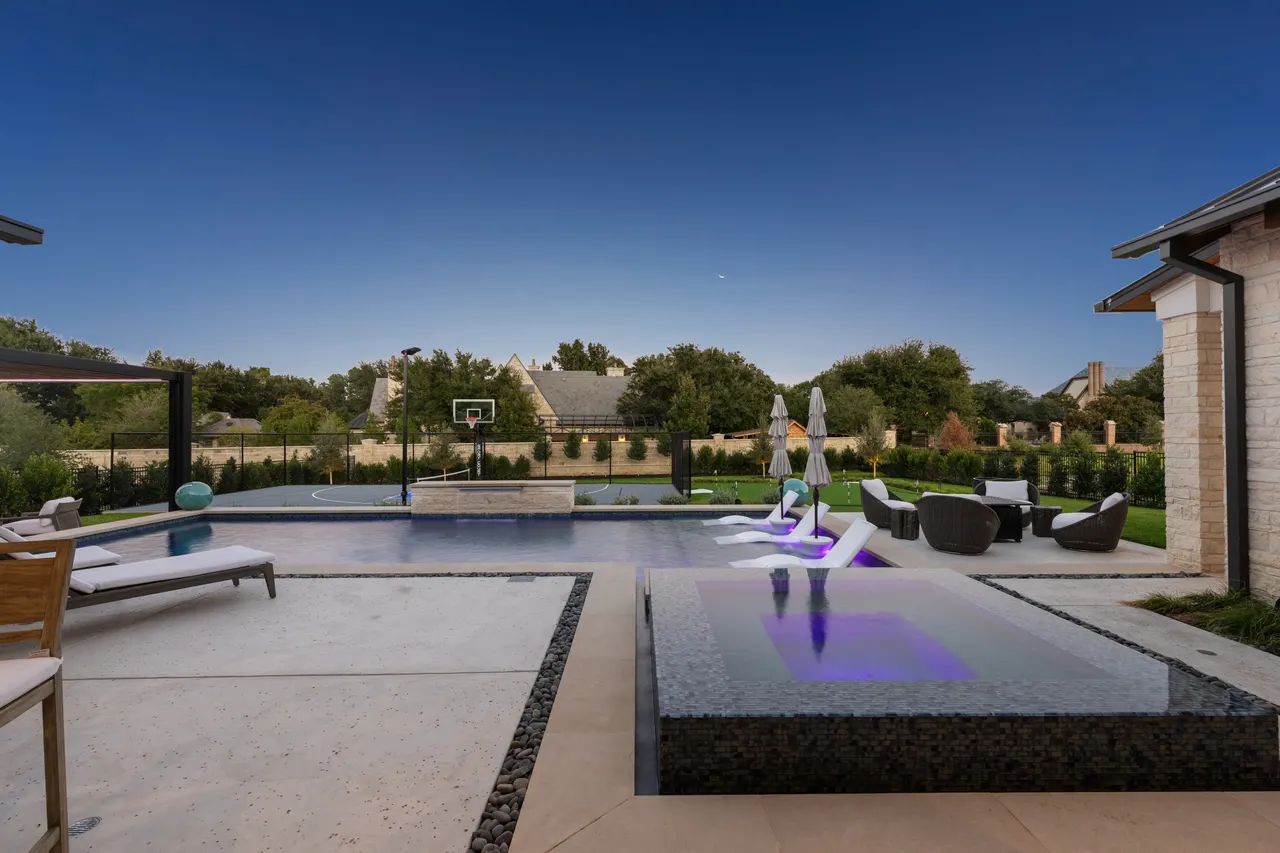 Custom pool with in-water loungers and cabana — Verde Outdoors